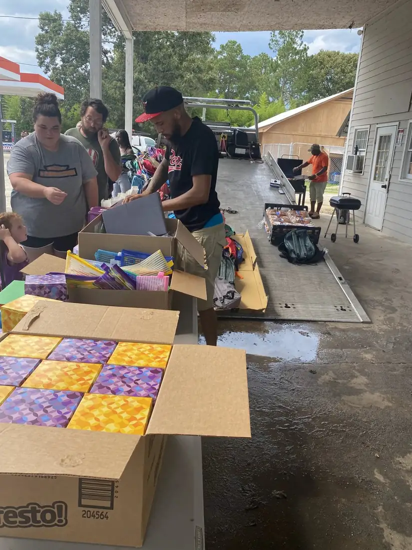Volunteers sorting school supplies for community families
