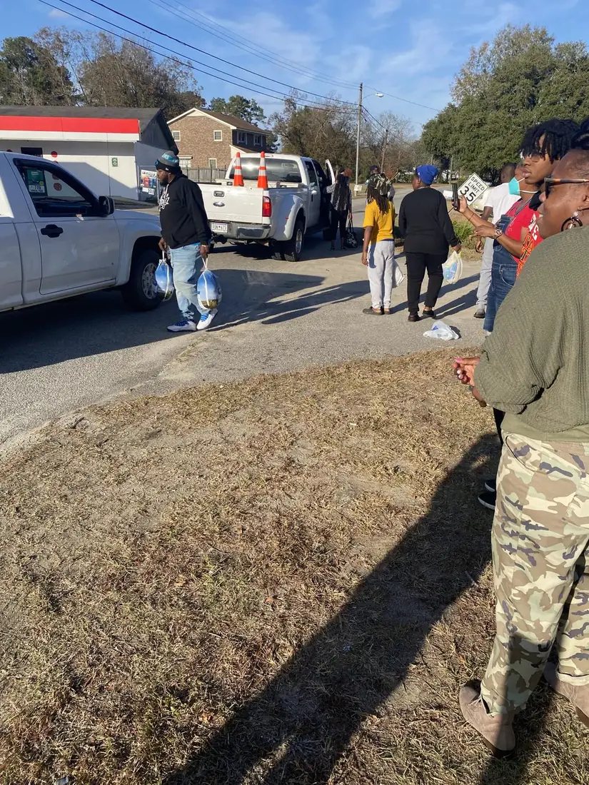Community members receiving food during a neighborhood distribution event
